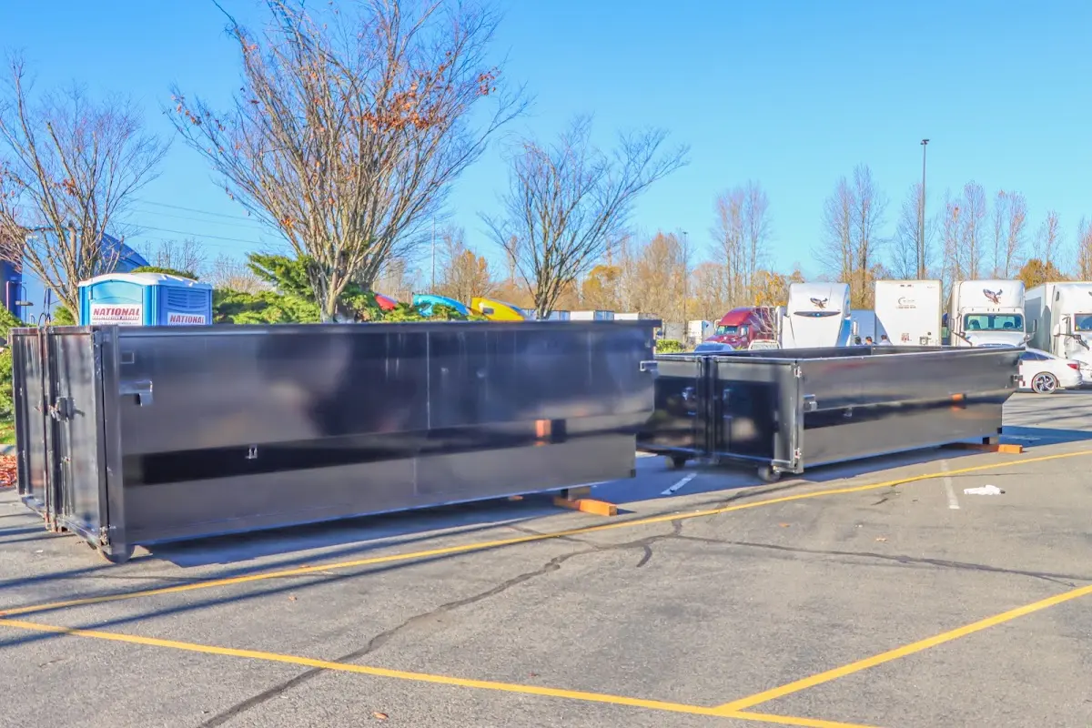 Professional dumpster rental service with roll-off container on residential driveway in Glocester